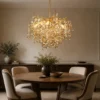 Gold branch crystal chandelier, Ø60cm, hanging over a round dining table