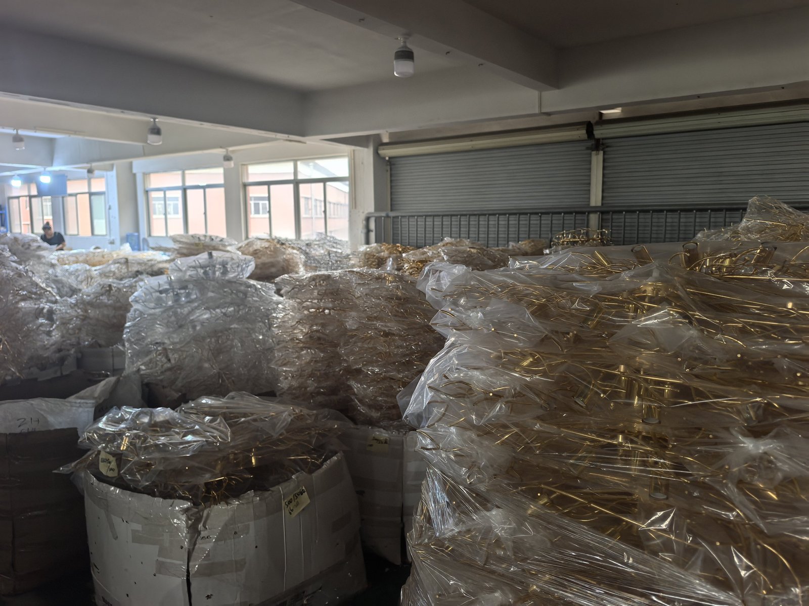 Gold-plated branch chandelier frames wrapped and palletised in the HongFu Lighting warehouse